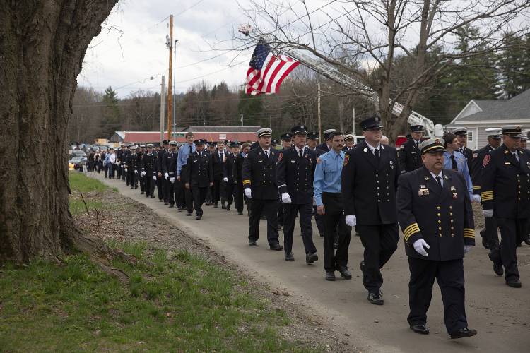 Firefighters from over a dozen fire departments across Vermont and New Hampshire march in the funeral procession for longtime Ascutney Fire Chief Darrin Spaulding, from Weathersfield Elementary School to Ascutneyville Cemetery in Ascutney, Vt., on Saturday, April 20, 2024. Spaulding, 59, a member of the fire service for over 40 years, served as Chief from 1995 until his passing on April 9. (Valley News / Report For America - Alex Driehaus) Copyright Valley News. May not be reprinted or used online without permission. Send requests to permission@vnews.com.