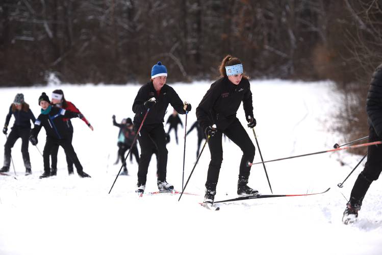 Lebanon High School nordic skiers start their practice with a number of warm-up laps on Monday, Jan. 8, 2024, in Meriden, N.H. It was the team's first practice on natural snow this winter. They have a meet scheduled at Plainfield Elementary School on Saturday.  (Valley News - Jennifer Hauck) Copyright Valley News. May not be reprinted or used online without permission. Send requests to permission@vnews.com.