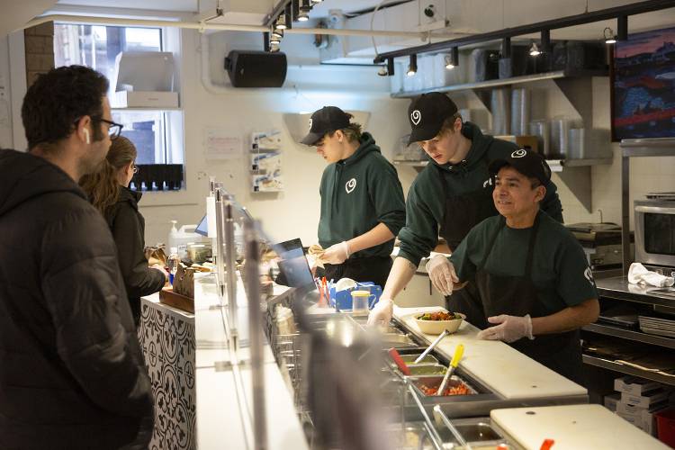 Boloco employees, from left, Kai Monarrez, Birken Silitch and Sixto Hernandez take customer orders at Boloco in Hanover, N.H., on Thursday, Feb. 15, 2024. (Valley News / Report For America - Alex Driehaus) Copyright Valley News. May not be reprinted or used online without permission. Send requests to permission@vnews.com.