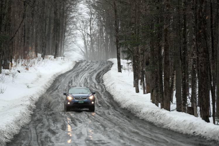 Myra Hudson, of Royalton, drives a rutted stretch of Royalton Turnpike in Barnard, Vt., on Wednesday, March 27, 2024. (Valley News - James M. Patterson) Copyright Valley News. May not be reprinted or used online without permission. Send requests to permission@vnews.com.