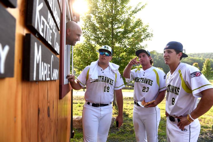 Before the start of their game, Upper Valley Nighthawks Matthew Russo, left, Jake Bullard and Nick Monistere order maple creamees at the Mac's Maple food truck on Wednesday, July 5, 2023, in White River Junction, Vt. Justin White takes their order. (Valley News - Jennifer Hauck) Copyright Valley News. May not be reprinted or used online without permission. Send requests to permission@vnews.com.