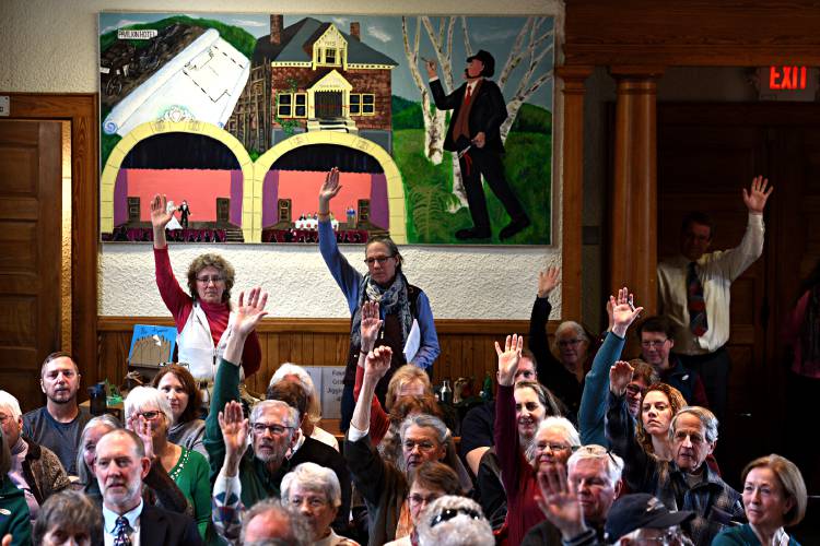 Hartland residents raise their hands during a vote at Town Meeting in Hartland, Vt., on Tuesday, March 3, 2020. (Valley News - Jennifer Hauck) Copyright Valley News. May not be reprinted or used online without permission. Send requests to permission@vnews.com.