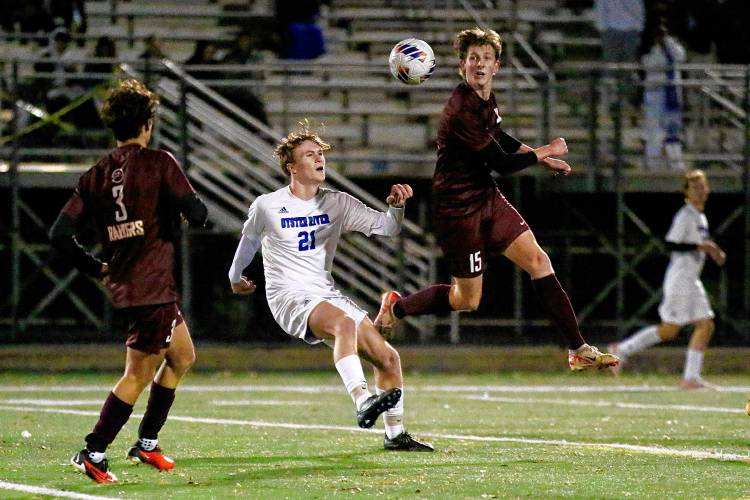 Lebanon High's Otto Bourne (15) leaps after heading the ball in front of Oyster River's Max Scopel during the NHIAA Division II teams' Oct. 31, 2023, playoff semifinal at Stellos Stadium in Nashua, N.H. Lebanon won, 1-0. (Valley News - Tris Wykes) Copyright Valley News. May not be reprinted or used online without permission. Send requests to permission@vnews.com