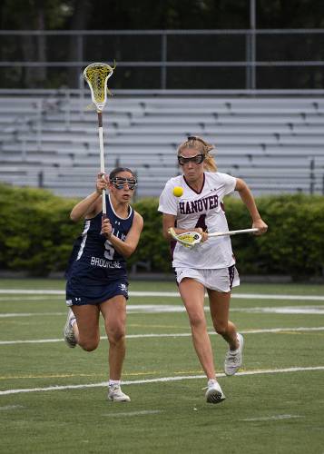 Hanover’s Maggie Higgins (4) gains control of the ball as she runs down the field, closely followed by Hollis-Brookline’s Izabella Haytayan (5) during the NHIAA Division II girls lacrosse championship game at Stellos Stadium in Nashua, N.H., on Tuesday, June 6, 2023. Hollis-Brookline won, 12-11. (Valley News / Report For America - Alex Driehaus) Copyright Valley News. May not be reprinted or used online without permission. Send requests to permission@vnews.com.