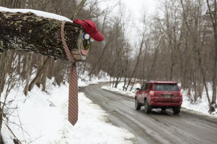 A smiling face warns drivers of an overhanging log at the side of Broad Brook Road between Royalton and East Barnard, Vt., on Wednesday, March 27, 2024. (Valley News - James M. Patterson) Copyright Valley News. May not be reprinted or used online without permission. Send requests to permission@vnews.com.