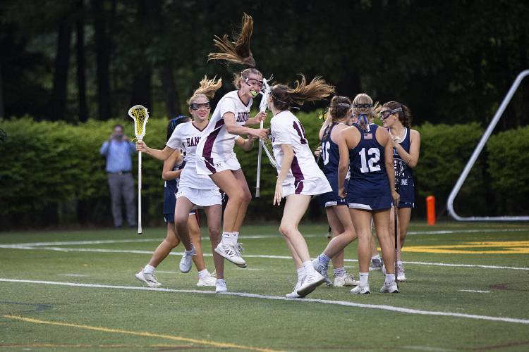 Hanover’s Maggie Higgins (4), Kali McDonnell (6) and Lauren Eiler (14) celebrate after scoring a goal during the NHIAA Division II girls lacrosse championship game against Hollis-Brookline High School at Stellos Stadium in Nashua, N.H., on Tuesday, June 6, 2023. Hollis-Brookline won, 12-11. (Valley News / Report For America - Alex Driehaus) Copyright Valley News. May not be reprinted or used online without permission. Send requests to permission@vnews.com.