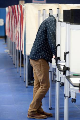 Hartford voter Greg Balsam fills out his ballot in the Hartford High School gym in White River Junction, Vt., Tuesday, March 4, 2020. (Valley News - James M. Patterson) Copyright Valley News. May not be reprinted or used online without permission. Send requests to permission@vnews.com.