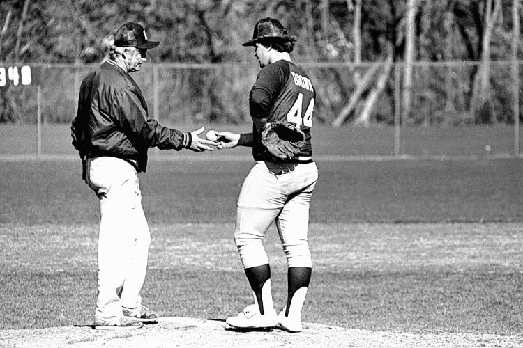 A grim-faced Chuck Hunnewell takes the ball from Alan Brown during a pitching change in the fourth inning of Hanover's 13-6 loss to Windsor on April 26, 1984. (Valley News - Tom Wolfe) Copyright Valley News. May not be reprinted or used online without permission. Send requests to permission@vnews.com.