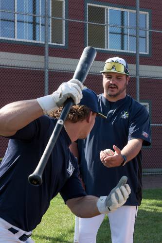 Nighthawks hitting coach Garrett Nance, right, works with Christopher Worcester on his swing before their game with Sanford at Maxfield Sports Complex in Hartford, Vt., on Thursday, July 20, 2023. Nance returned to the team this year after interning with the Nighthawks in 2017. (Valley News - James M. Patterson) Copyright Valley News. May not be reprinted or used online without permission. Send requests to permission@vnews.com.
