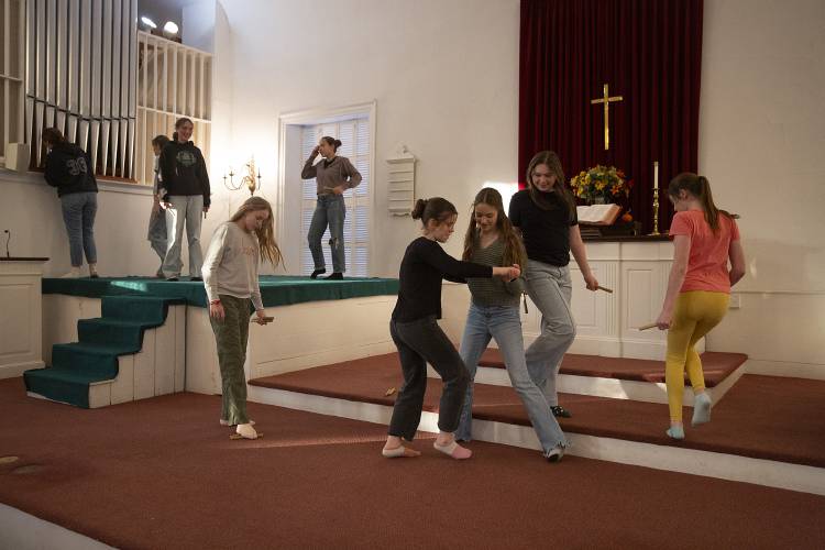 Della Cote, 13, center left, and Hannah Eck, 14, center right, both of Lyme, N.H., tango across the stage before the middle school angels rehearsal for the Lyme Christmas Pageant at Lyme Congregational Church on Monday, Nov. 27, 2023. The 10 middle school angels will be joined onstage by several dozen shepherds, cherubs and high school angels. (Valley News / Report For America - Alex Driehaus) Copyright Valley News. May not be reprinted or used online without permission. Send requests to permission@vnews.com.