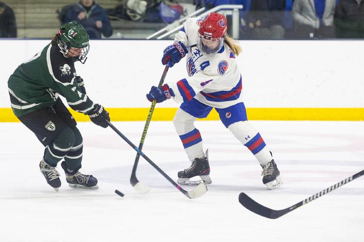 Hartford’s Emma Bazin (5) fights for the puck against Stowe’s Isabel Donza (7) during a VPA D-II girls hockey quarterfinal game at Wendell A. Barwood Arena in White River Junction, Vt., on Wednesday, Feb. 28, 2024. (Valley News / Report For America - Alex Driehaus) Copyright Valley News. May not be reprinted or used online without permission. Send requests to permission@vnews.com.