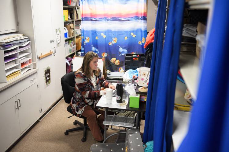 Mary Lawrence, a student assistance professional, works in a storage room at Sharon Elementary in Sharon, Vt., on Thursday, Nov. 30, 2023, where she shares space one-on-one meetings with students with the school's behavior specialist and the school counselor. There is also a counselor's office that can accommodate small groups, or one-on-one meetings when scheduling allows. (Valley News - James M. Patterson) Copyright Valley News. May not be reprinted or used online without permission. Send requests to permission@vnews.com.