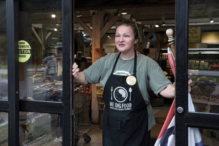 Lead cashier Nina Paczykowski opens the The Woodstock Farmers Market for the first time in 56 days in West Woodstock, Vt., on Friday, Sept. 8, 2023 after it was forced to close by the floods of July. Customers began congregating at the doors shortly before 8 a.m. (Valley News - James M. Patterson) Copyright Valley News. May not be reprinted or used online without permission. Send requests to permission@vnews.com.