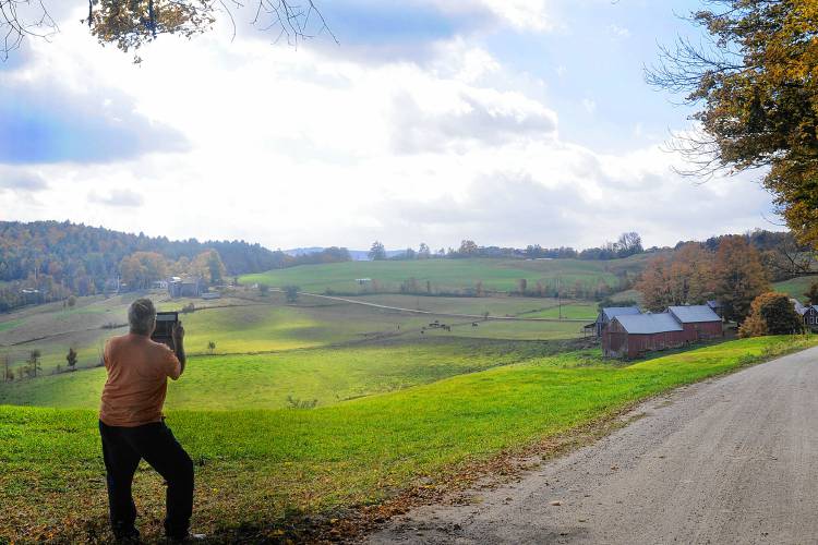 Basil Bixby, of New Smyrna Beach, Fla., uses his IPad to photograph the Jenne Farm in Reading, Vt., on Oct. 2, 2013. It was Bixby's first time at the famous farm, which has appeared in the 1994 movie Forrest Gump and a Budweiser commercial, but he had trouble finding it, passing the obscure dirt road a few times before he found it. (Valley News - Sarah Priestap) Copyright Valley News. May not be reprinted or used online without permission. Send requests to permission@vnews.com. 