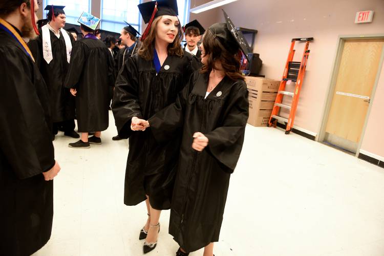Classmates Madison Wheeler, left, and Grace Seale react to the call going out to line up for the start of the Stevens High School commencement ceremony on Thursday, June 8, 2023, in Claremont, N.H. (Valley News - Jennifer Hauck) Copyright Valley News. May not be reprinted or used online without permission. Send requests to permission@vnews.com.