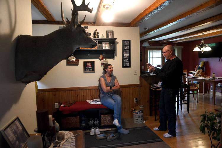 Large animal veterinarian Taylor Hull talks with farmer Charlie Carrier at his home in Williamstown, Vt. on Thursday, July 27, 2023 after doing pregnancy checks on several cows in his herd. (Valley News - Jennifer Hauck) Copyright Valley News. May not be reprinted or used online without permission. Send requests to permission@vnews.com.