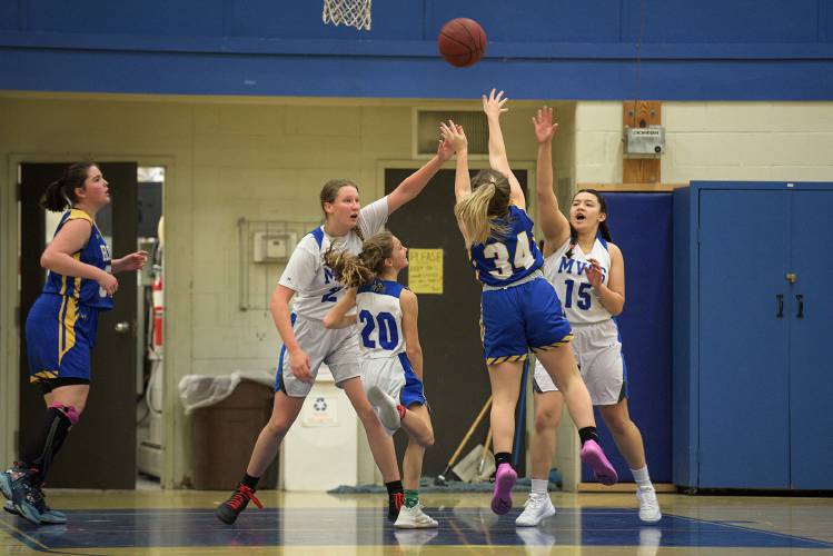 Emily Handley, of Poultney, shoots over Mid Vermont Christian players, from left, Lydia Dickey, left, Rebekah Roberts, and Jorja DuPlessis in Quechee, Vt., on Thursday, Dec. 15, 2022. Jacqueline Oberg, of Poultney, is at left. Poultney won 42-14. (Valley News - James M. Patterson) Copyright Valley News. May not be reprinted or used online without permission. Send requests to permission@vnews.com.
