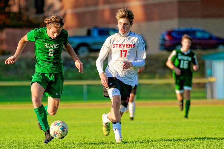 Stevens High's Owen Chapman, right, shadows Hopkinton's Liam O'Brien during the NHIAA Division III teams' first-round playoff game on Oct. 24, 2023, in Hopkinton, N.H. Hopkinton won, 5-0. (Valley News - Tris Wykes) Copyright Valley News. May not be reprinted or used online without permission. Send requests to permission@vnews.com.