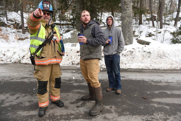 Andrew Cloutier, a resident of Lake Sunapee Manor, talks with John Gosselin of the Sunapee Fire Department at the scene of a structure fire on Friday, Jan. 19, 2024, in Sunapee, N.H. At around 7 p.m. on Thursday night, Cloutier's neighbor came to him about smoke in his apartment. The two then went through the 14 units in the building, telling people to get out. Cloutier was at the scene the next day, hoping he may be able to get some things out of his apartment. He was staying with friends. Behind Cloutier is his friend Brian Larson, of Newport, N.H.  (Valley News - Jennifer Hauck) Copyright Valley News. May not be reprinted or used online without permission. Send requests to permission@vnews.com.