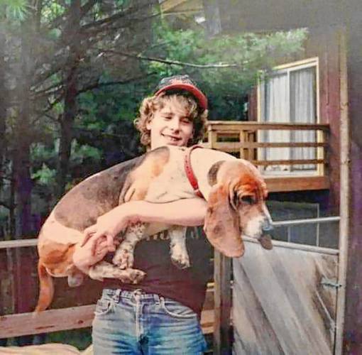 Chris Conant with the family Basset Hound, named Arthur, at his mother Carol Hanna's house in Acworth, N.H., in the mid-1980s. Chris was born in 1970. (Family photograph)