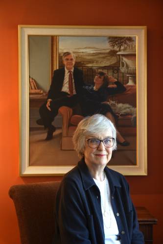 Susan Gillotti, of Hanover, N.H., has become an advocate for the proposed New Hampshire aid-in-dying bill. While living in Vermont, Gillotti's husband, Al Gillotti was protected by its state law allowing terminally ill people to end their lives. Behind Gillotti is a portrait of her and her husband. (Valley News - Jennifer Hauck) Copyright Valley News. May not be reprinted or used online without permission. Send requests to permission@vnews.com.