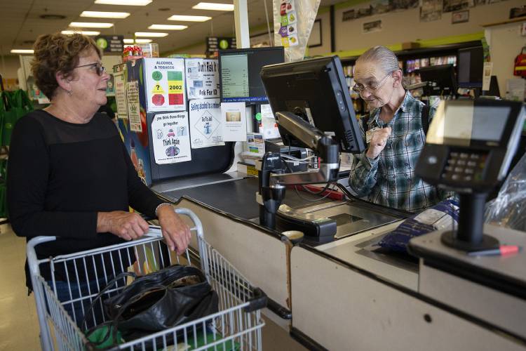 Evelyn Adams, 69, of White River Junction, Vt., rings up items for Jill Vahey, of Hartford, Vt., at the Co-op Food Store in White River Junction on Friday, August 25, 2023. Several shoppers choose Adams’ register just to stop and chat with her. “She is quite a celebrity here,” said Ryan Madden, of White River Junction, a former co-op employee and current shopper who made a point to visit with Adams as he arrived at the store. (Valley News / Report For America - Alex Driehaus) Copyright Valley News. May not be reprinted or used online without permission. Send requests to permission@vnews.com.