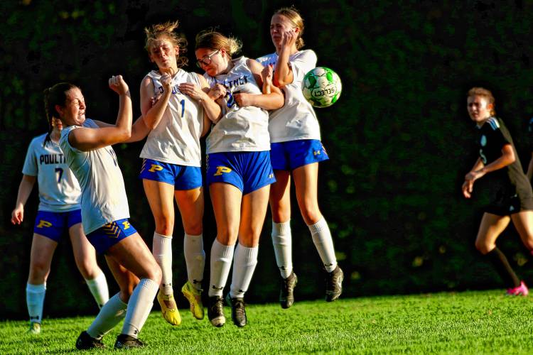 Sharon Academy's Maddy Mintz, right, watches as Poultney players, from left, Kaitlin DeBonis, Bella Mack, Jade Thomas and Emma Kelley react to the arrival of a free kick during the Vermont Division IV teams' Oct. 3, 2023, in Sharon, Vt. Poultney won, 7-3. (Valley News - Tris Wykes) Copyright Valley News. May not be reprinted or used online without permission. Send requests to permission@vnews.com.