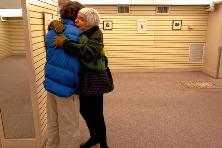 Marie Kirn hugs her longtime friend Eric Hasse at Hasse's gallery in Hanover, N.H., on Dec. 19, 2006, which showcases his work. (Valley News - Channing Johnson) Copyright Valley News. May not be reprinted or used online without permission. Send requests to permission@vnews.com.