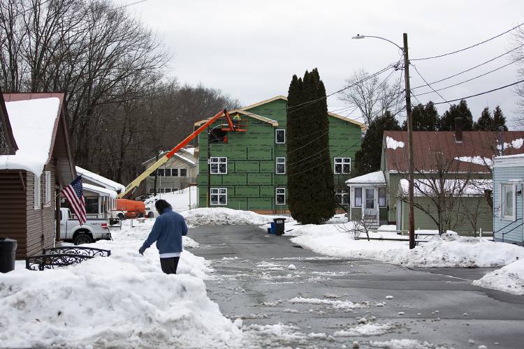 A crew from Ingram Construction Corporation works on building an 18-unit apartment building behind St. Paul's Episcopal Church in White River Junction, Vt., on Thursday, Jan. 25, 2024. The Twin Pines Housing project, which broke ground in August 2023, is intended to provide permanent housing for individuals experiencing long-term homelessness, who will also receive case management services from the Upper Valley Haven next door. (Valley News / Report For America - Alex Driehaus) Copyright Valley News. May not be reprinted or used online without permission. Send requests to permission@vnews.com.