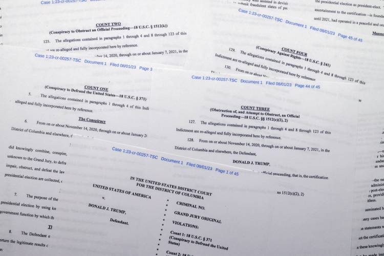 The indictment against former President Donald Trump charging him by the Justice Department for his efforts to overturn the results of the 2020 presidential election is photographed Tuesday, Aug. 1, 2023, in Washington. (AP Photo/Jon Elswick)
