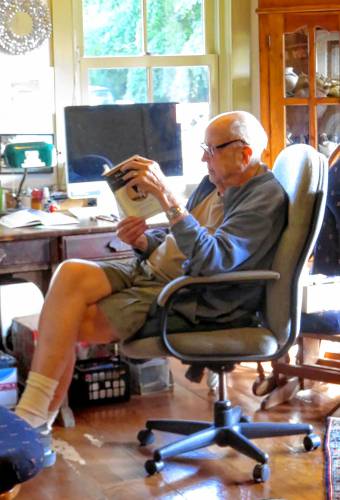 Joe Medlicott, a much admired scholar and teacher of literature, spends some quiet time reading. (Famliy photograph)