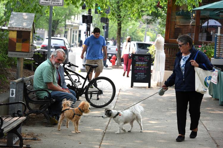 Robin Burdette, of Quechee, Vt., with her dog Lulu say hello to Loki in Hanover, N.H. on Tuesday, June 6, 2023. Loki's owners Diane and Peter Carson, of Groton, Mass., were in town visiting family. Hanover is seeking public feedback for new outdoor downtown seating. (Valley News - Jennifer Hauck) Copyright Valley News. May not be reprinted or used online without permission. Send requests to permission@vnews.com.