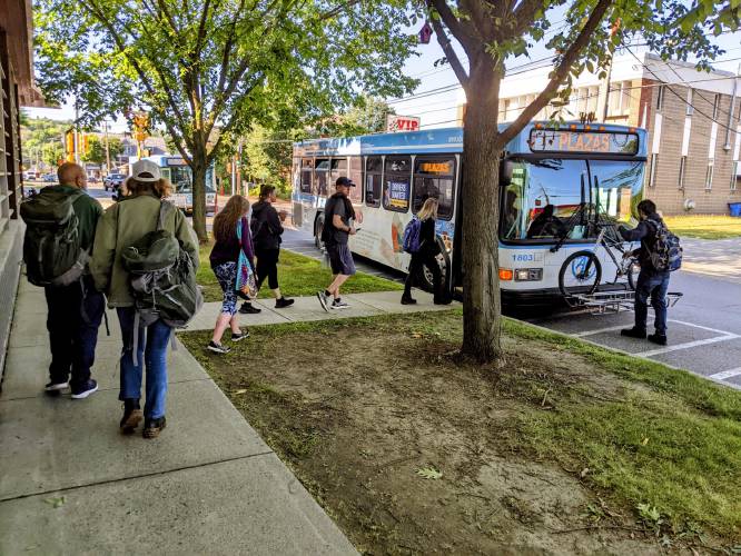 Passengers board an Advance Transit bus on a July morning from a stop outside the Kilton Public Library in West Lebanon. (Courtesy Advance Transit)