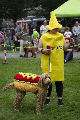 Tess Malloy, of Plymouth, Vt., dresses to match her neighbor’s 8-year-old labradoodle Lucy during Puppies and Pooches On Parade on the green in Woodstock, Vt., on Saturday, August 26, 2023. Hot dogs were also available at the event’s concession stand. (Valley News / Report For America - Alex Driehaus) Copyright Valley News. May not be reprinted or used online without permission. Send requests to permission@vnews.com.