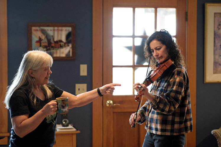 Beth Telford, left, helps student Lauren Bomalaski, of Tunbridge, work through a tune during a lesson at her home in Braintree, Vt., on Wednesday, March 6, 2024. Bomalaski started playing last September and is now learning jigs and reels. (Valley News - James M. Patterson) Copyright Valley News. May not be reprinted or used online without permission. Send requests to permission@vnews.com.