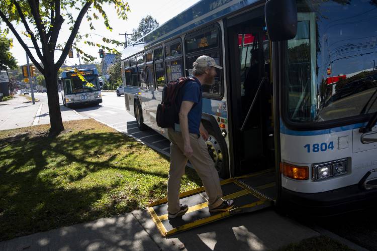 Kevin Leveret, of White River Junction, Vt., boards his bus at the Advance Transit bus stop in front of Kilton Library in West Lebanon, N.H., on Monday, Oct. 2, 2023. The bus is Leveret’s primary mode of transportation, and he said it’s hard to beat the free fare and regular schedule. “It’s so convenient,” he said. (Valley News / Report For America - Alex Driehaus) Copyright Valley News. May not be reprinted or used online without permission. Send requests to permission@vnews.com.