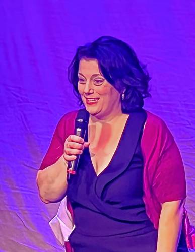 Comedian Vicki Ferentinos performs in an undated photograph. Ferentinos, of Woodstock, Vt., will be performing in the sold-out show “F Words: Funny. Females” at Artistree’s Grange Theater in Pomfret, Vt., on March 23, 2024. (Courtesy photograph)