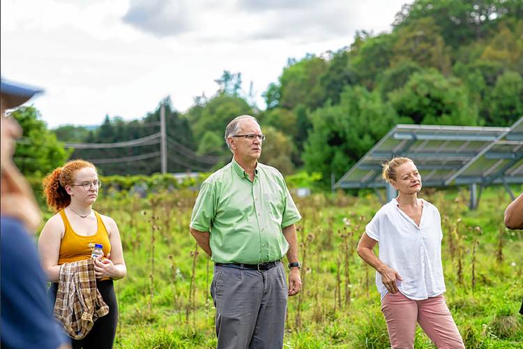 Kevin Jones with students in front of the law school's solar array located in Royalton, Vt., in an undated photograph. It was the first project completed by the VLGS Energy Clinic, which Jones created in 2014. (Courtesy photograph) 
