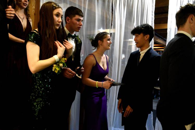 Josh Park, right, waits with friends Kamdyn Aldrich, left, Cameron Jespersen-Pecor and Alanna Cilbrith for their turn in the photo booth at Mascoma Valley Regional High School's prom on Saturday, May 13, 2023, at Ragged Mountain Resort in Danbury, N.H. They are all teammates on the Mascoma track team.  (Valley News - Jennifer Hauck) Copyright Valley News. May not be reprinted or used online without permission. Send requests to permission@vnews.com.