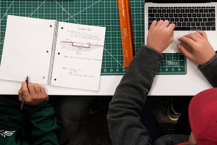Peter Borden, right, looks up prices for components of an in-ground trampoline as Isaac Emery, left, takes notes during their IDEA class at Woodstock Union High School in Woodstock, Vt., Thursday, Nov. 15, 2018. (Valley News - James M. Patterson) Copyright Valley News. May not be reprinted or used online without permission. Send requests to permission@vnews.com.