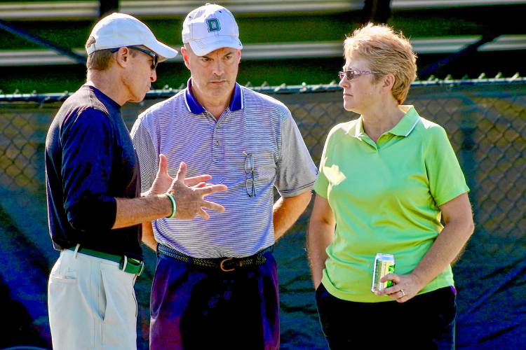Dartmouth College head football coach Buddy Teevens, left, speaks with Tom and Kim Hoyt of West Lebanon, before the Big Green's Aug. 25, 2019, practice the Blackman Fields. The Hoyts are longtime participants in the program's mentor program, pairing local adults with Dartmouth players for support.