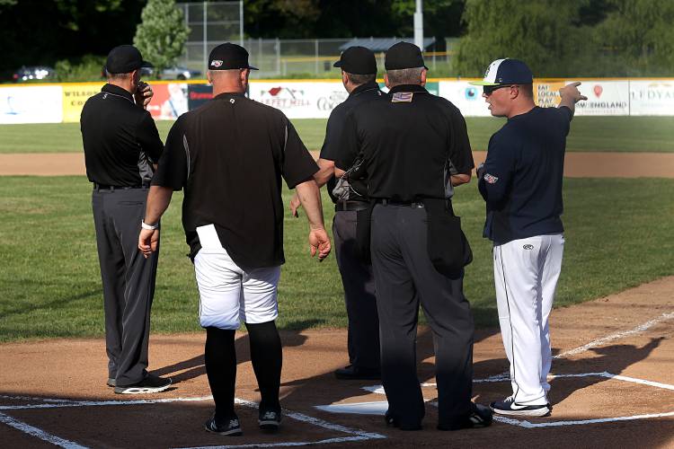 Upper Valley Nighthawks manager Mat Pause, right, talks about the field of play with Keene Swamp Bats manager Shaun McKenna, second from left, and officials before the first pitch of their NECBL game in White River Junction, Vt., on June 15, 2023. (Valley News - Geoff Hansen) Copyright Valley News. May not be reprinted or used online without permission. Send requests to permission@vnews.com.