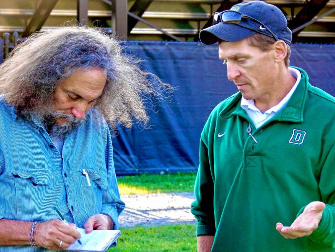 Dartmouth College head football coach Buddy Teevens conducts an interview with Valley News sports editor and columnist Don Mahler on the Blackman Fields after a 2009 practice.