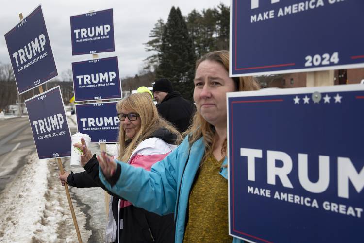 Deborah Chase, left, and Nancy LaClair, both of Claremont, N.H., wave to passersby while holding Donald Trump signs outside Claremont Middle School in Claremont, N.H., on Tuesday, Jan. 23, 2024. Both women have campaigned for Trump previously, and Chase said people are still enthusiastic about him but those who think the 2020 election was stolen now seem more wary of the election process. (Valley News / Report For America - Alex Driehaus) Copyright Valley News. May not be reprinted or used online without permission. Send requests to permission@vnews.com.