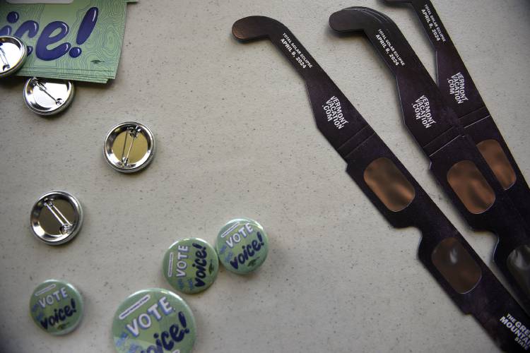 Solar eclipse glasses and buttons were some of the items up for grabs at the polls in Norwich, Vt., on Tuesday, March 5, 2024. 
 (Valley News - Jennifer Hauck) Copyright Valley News. May not be reprinted or used online without permission. Send requests to permission@vnews.com.