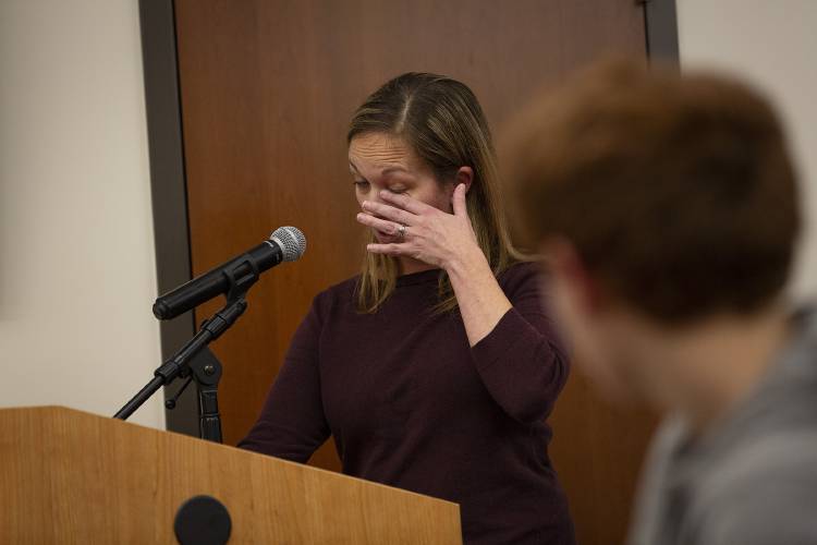 Rebecca Whitney, of White River Junction, Vt., wipes tears from her eyes as she recounts the bullying her son endured during his time at Hartford Memorial Middle School, which ranged from cyberbullying to being hit with a metal water bottle, during a Hartford School Board meeting at Hartford Town Hall in White River Junction, Vt., on Wednesday, Dec. 13, 2023. Whitney credited former interim principal Justin Bouvier with making her son’s last year in middle school tolerable by creating a 10-point safety plan and looking out for him while he was in the building. (Valley News / Report For America - Alex Driehaus) Copyright Valley News. May not be reprinted or used online without permission. Send requests to permission@vnews.com.