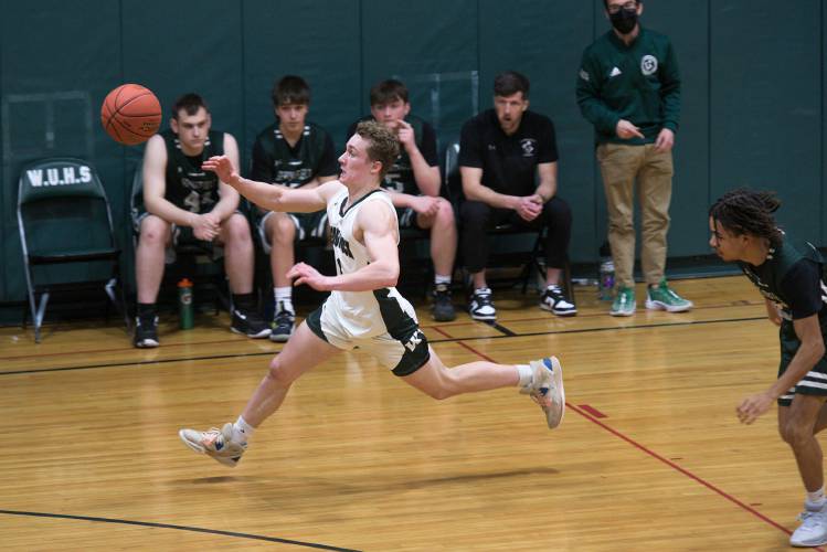 Caeden Perreault, of Woodstock, left, chases a pass on a break away trailed by Cam Williams, of Springfield, in Woodstock, Vt., on Monday, Jan. 29, 2024. Woodstock took the lead through the first half before Springfield's third quarter comeback that held for a 50-41 win. (Valley News - James M. Patterson) Copyright Valley News. May not be reprinted or used online without permission. Send requests to permission@vnews.com.