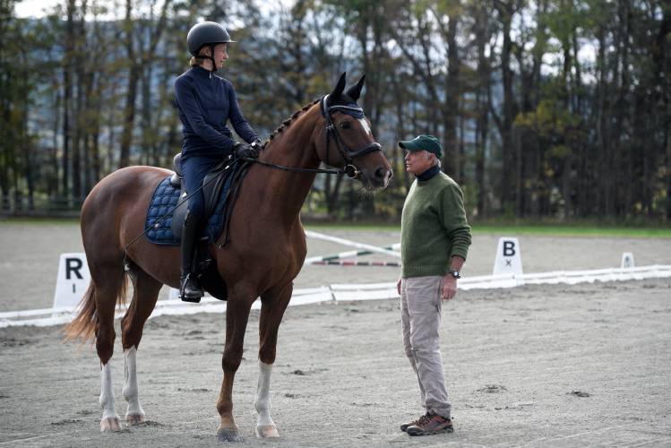 Equestrian Coach Denny Emerson, of Strafford, right, talks with Marta White, riding Beaulieu's Simply Cool, as they prepare for a demonstration at the High Horses 30th annual benefit trail ride and nature walk at Pirouette Farm in Norwich, Vt., on Saturday, Oct. 14, 2023. White, who has progressive multiple sclerosis, teamed up with Simply Cool, who has recovered from what was thought to be a career-ending back injury, with hopes to join the U.S. Paralympic equestrian team. White spoke to participants in the High Horses benefit about their experience of healing together. 