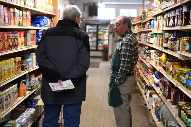 Earl Varney, of South Strafford, Vt., chats with Melvin Coburn, owner of Coburns' General Store on Friday, Jan. 26, 2024, in South Strafford. Varney's family formerly owned the store. The Coburn family is looking to sell the store -- the Strafford Community Trust is rasing money to purchase the operation. (Valley News - Jennifer Hauck) Copyright Valley News. May not be reprinted or used online without permission. Send requests to permission@vnews.com.