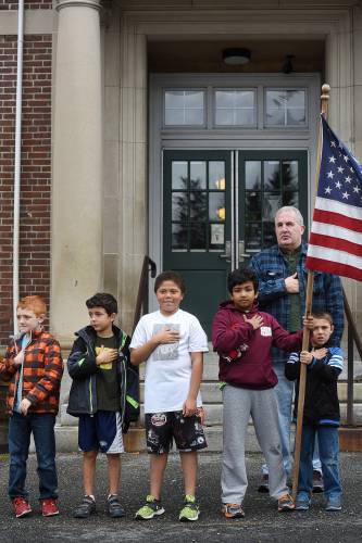 As he does every year, Jim Vanier, youth center coordinator at the Carter Community Building in Lebanon, N.H., show his respects along with students from CCB's drop-in program during the annual Veterans Day parade Wednesday in downtown Lebanon. Among the participants was U.S. Sen. Bernie Sanders (See Primary Source on page B1). on Nov. 11, 2015. (Valley News - Sarah Priestap) <p><i>Copyright � Valley News. May not be reprinted or used online without permission. Send requests to permission@vnews.com.</i></p>